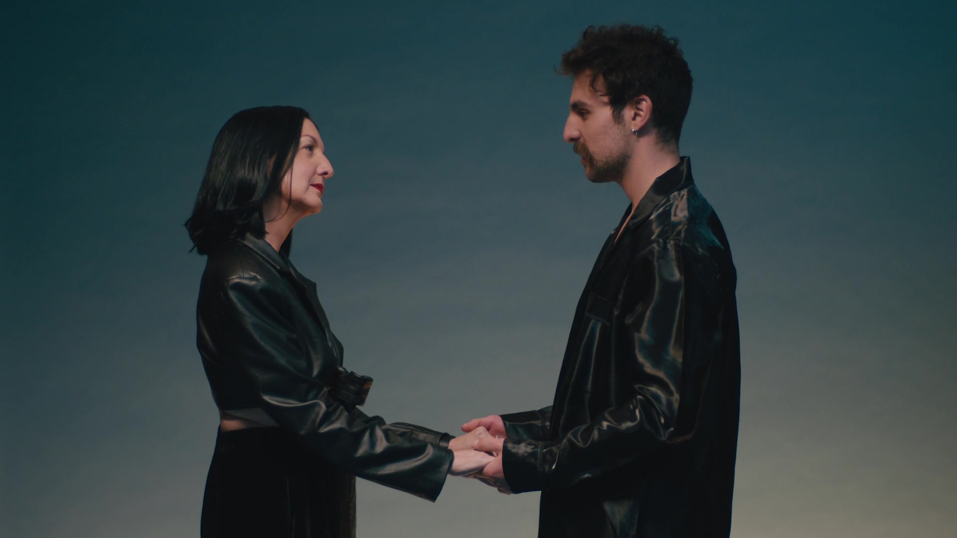 Matching black leather, hands held